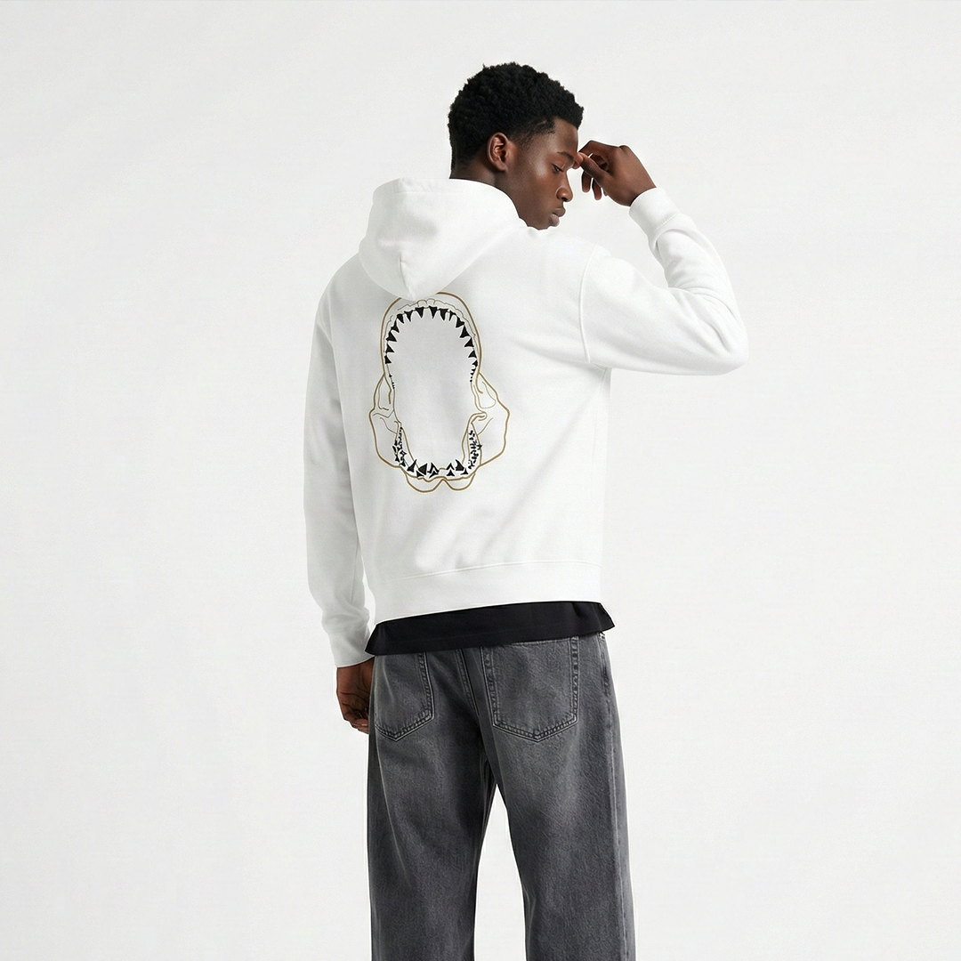 Man wearing white shark graphic hoodie, marine lifestyle streetwear apparel
