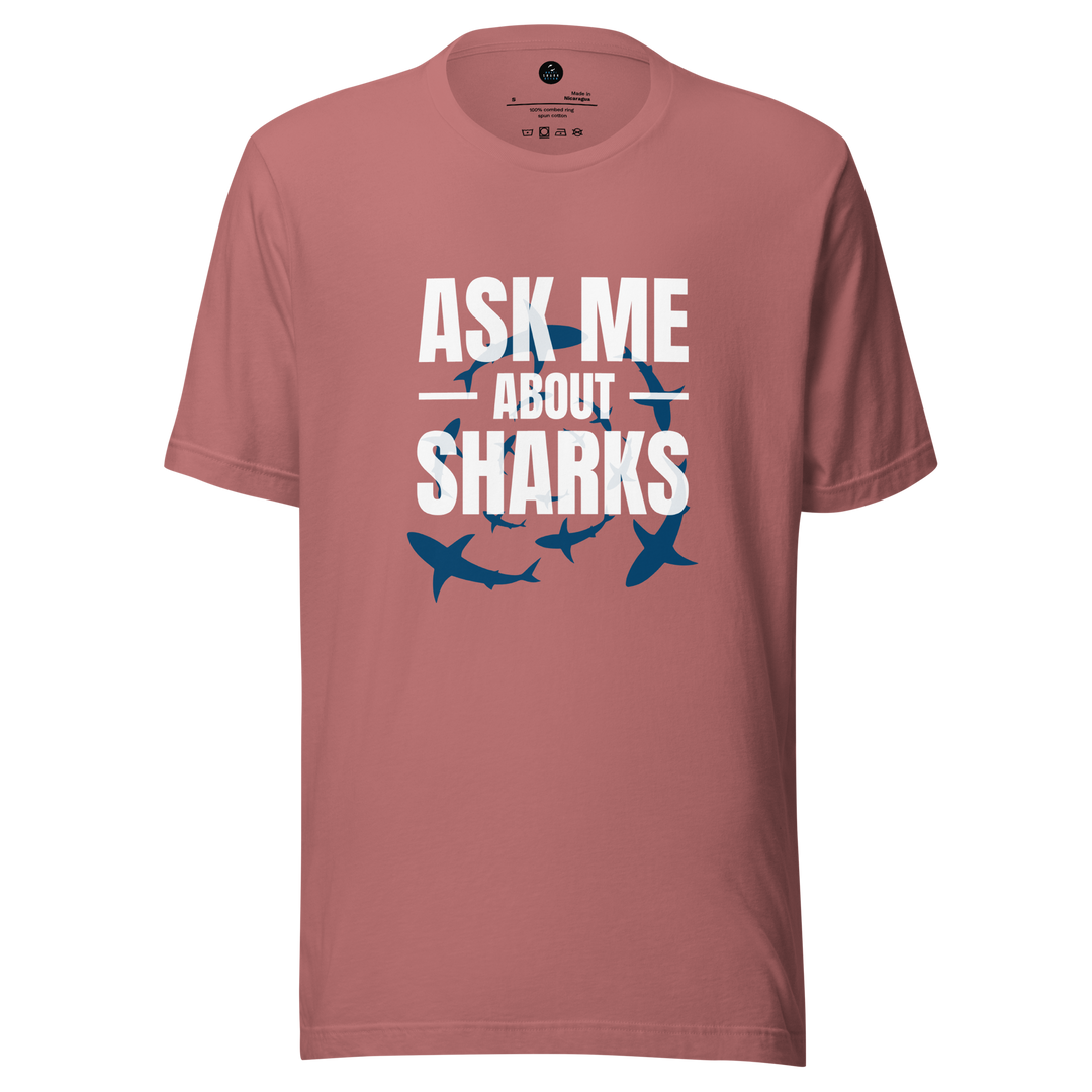 Pink t-shirt with 'Ask Me About Sharks' text and shark illustrations on a white background