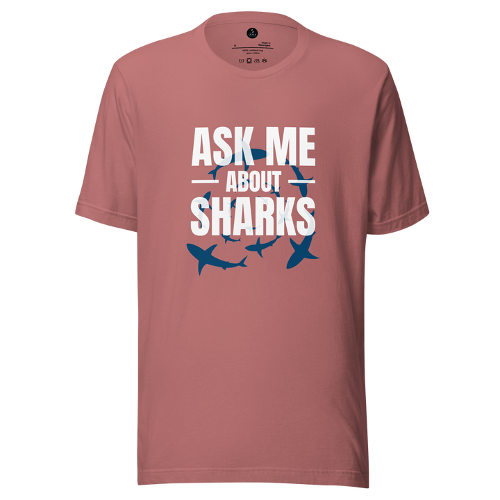 Pink t-shirt with 'Ask Me About Sharks' text and shark illustrations on a white background
