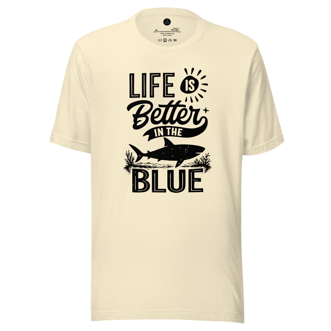 Beige t-shirt with 'Life is Better in the Blue' text and shark graphic on a white background