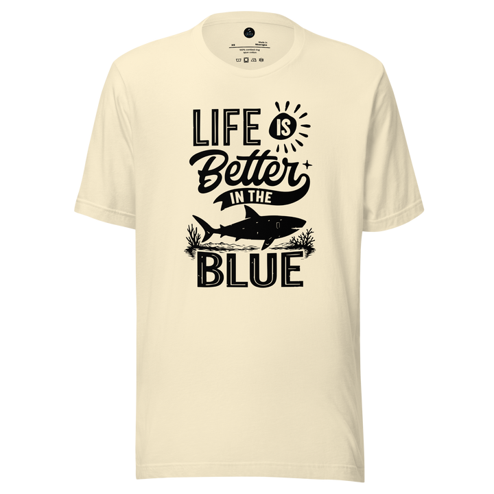 Beige t-shirt with 'Life is Better in the Blue' text and shark graphic on a white background