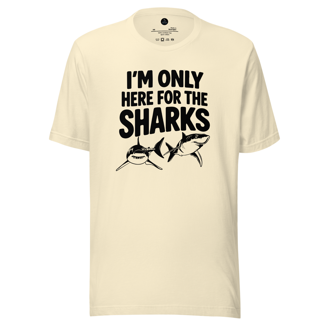 Beige t-shirt with 'I'm only here for the sharks' text and shark graphics on a white background